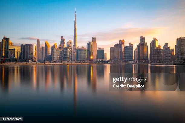 long exposure of the business bay dubai city skyline at twilight, united arab emirates - urban skyline stock pictures, royalty-free photos & images