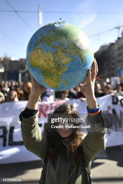 Protester holds a small globe during the global climate strike on March 3, 2023 in Turin, Italy. Young climate activists are expected to walk out of...