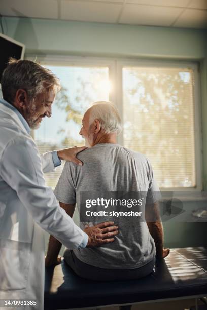 let me examine your back! - backache stock pictures, royalty-free photos & images