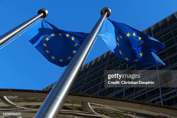 european union flags waving at berlaymont building of the european commission - europäische kultur stock-fotos und bilder