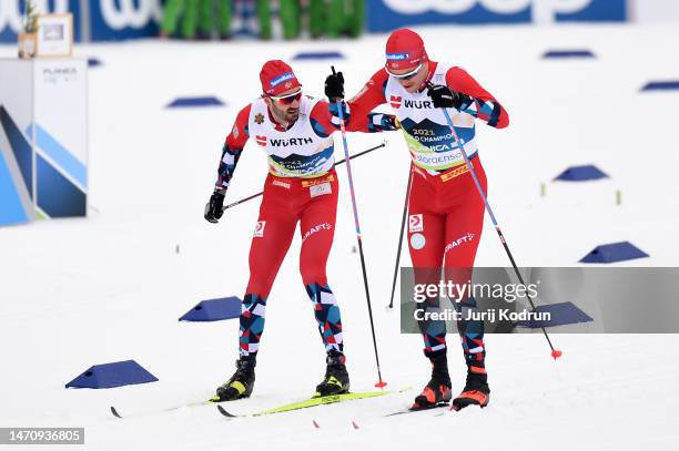 Hans Christer Holund of Team Norway changes over to Paal Golberg of Team Norway during the Cross-Country Men's 4x10km Relay Classic/Free at the FIS...