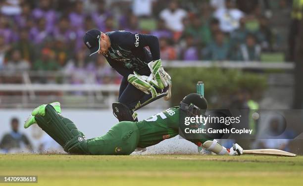 Shakib Al Hasan of Bangladesh dives to make his ground as Jos Buttler of England attempts to run him out during the 2nd One Day International match...