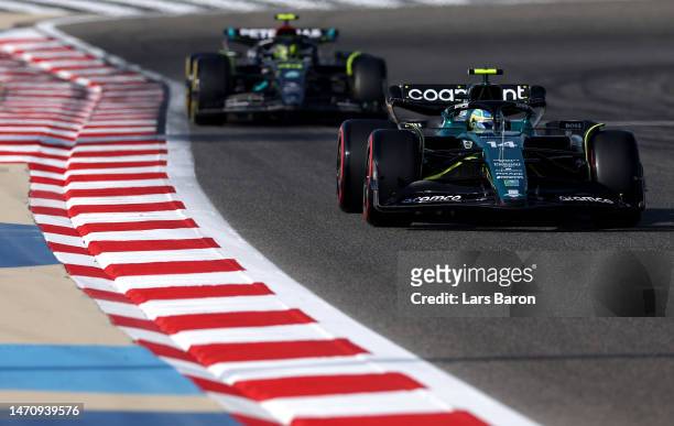 Fernando Alonso of Spain driving the Aston Martin AMR23 Mercedes leads Lewis Hamilton of Great Britain driving the Mercedes AMG Petronas F1 Team W14=...