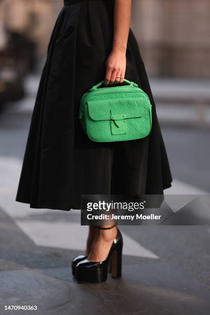 Füsun Lindner seen wearing Alexander McQueen black pleated long skirt, Louis Vuitton green leather handbag, Sportmax shiny black fringed vest,...