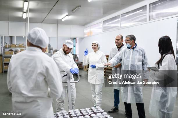 ceo asks workers about transporting techniques with manual forklift in food processing plant - sorting hat stock pictures, royalty-free photos & images