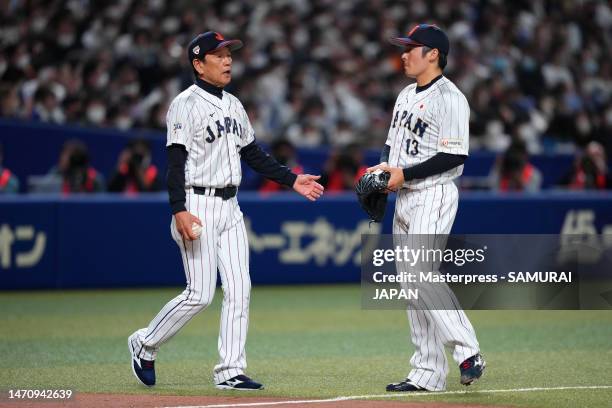 Head coach Hideki Kuriyama of Samurai Japan talks to Pitcher Yuki Matsui after allowing Shuhei Takahashi of Chunichi Dragons a RBI single in the...