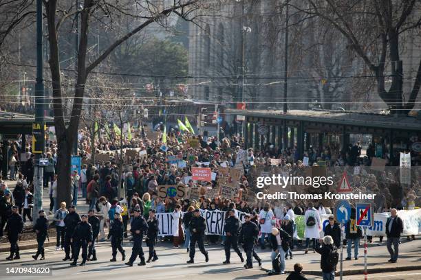 Supporters of the Fridays for Future climate action movement hold up a banners and signs during a global climate strike on March 03, 2023 in Vienna,...