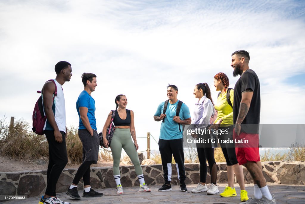 Friends talking while taking a break on a hike outdoors