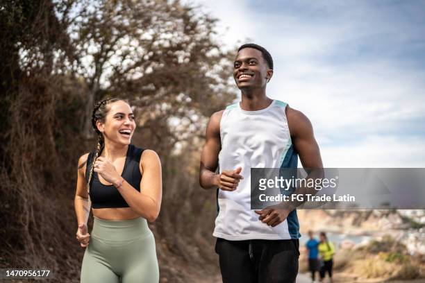 friends talking while running outdoors - 20 years stock pictures, royalty-free photos & images