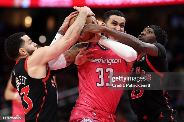 Kyle Kuzma of the Washington Wizards is fouled by Chris Boucher of the Toronto Raptors during the second half at Capital One Arena on March 2, 2023...