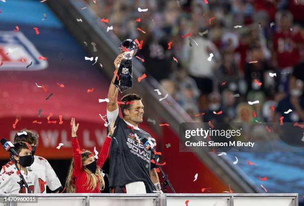 Tom Brady raises the Lombardi Trophy with his daughter Vivian Brady during the award ceremony for Super Bowl LV at Raymond James Stadium on February...