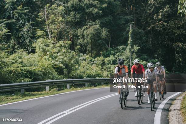 asian chinese female cyclist leading in rural cycling event - cycling event stock pictures, royalty-free photos & images