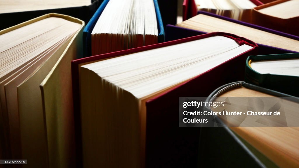 Close-up of anonymous books between shadows and light