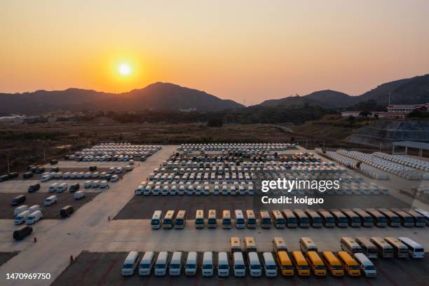 the electric car factory is full of electric cars at sunset - electric car factory stock pictures, royalty-free photos & images