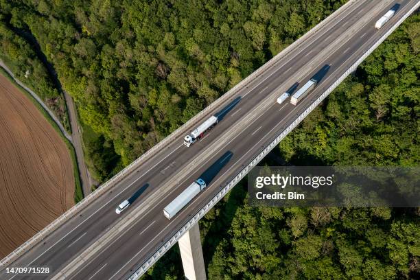 truck traffic on highway bridge, aerial view - motorway stock pictures, royalty-free photos & images