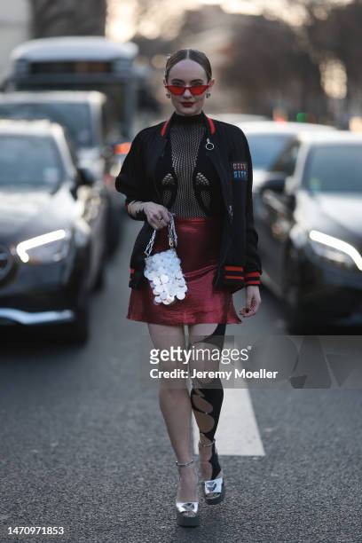 Katya Bychkova seen wearing black / red Paco Rabanne jacket with print on the back, silver glittering Paco Rabanne bag, red Fannie Schiavoni shiny...