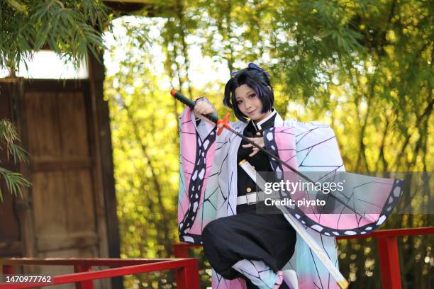 Japan anime cosplay portrait of girl with comic costume with japanese theme garden