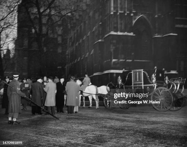 Guardsman with a long staff used to check the clearance beneath arches on the State Landau's route during rehearsals for the Coronation procession,...