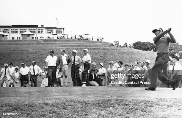 Spectators look on as golfer Sewsunker "Papwa" Sewgolum from South Africa of ethnic Indian origin watches his drive shot off the 8th tee during the...