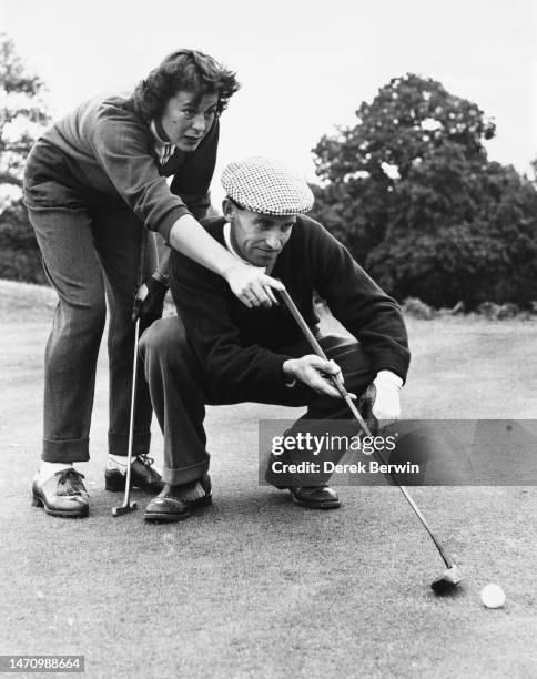 English golfers Marley Spearman and playing partner Doug Sewell during the Worplesdon Mixed Foursomes golf tournament on 12th October 1959 at the...