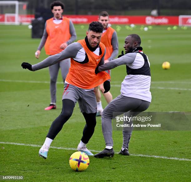 Alex Oxlade-Chamberlain and Naby Keita of Liverpool during a training session at AXA Training Centre on March 03, 2023 in Kirkby, England.