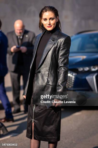 Olivia Palermo wears a black turtleneck top, black Givenchy midi skirt, black heels and black leather blazer, outside Givenchy, during Paris Fashion...