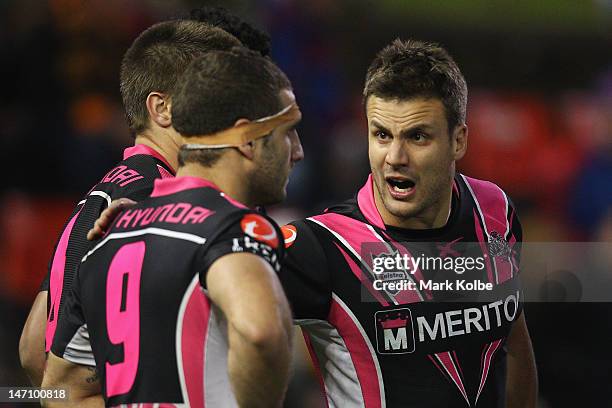 Beau Ryan of the Tigers gives encouragement to Robbie Farah of the Tigers during the round 16 NRL match between the Newcastle Knights and the Wests...