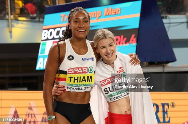 Nafissatou Thiam of Belgium celebrates alongside Adrianna Sulek of Poland after winning the Women's Pentathlon with a New World Record during Day 1...