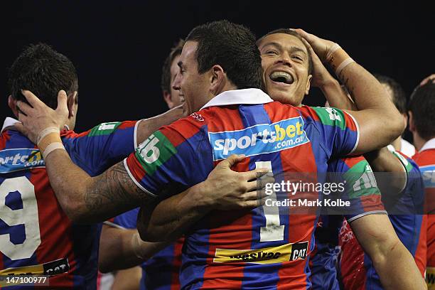 Timana Tahu of the Knights celebrates with his team mates after scoring a try during the round 16 NRL match between the Newcastle Knights and the...