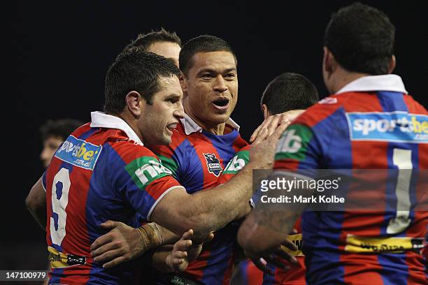 Timana Tahu of the Knights celebrates with his team mates after scoring a try during the round 16 NRL match between the Newcastle Knights and the...