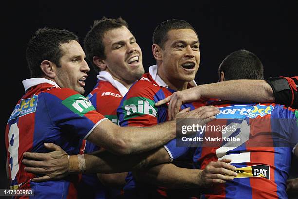 Timana Tahu of the Knights celebrates with his team mates after scoring a try during the round 16 NRL match between the Newcastle Knights and the...