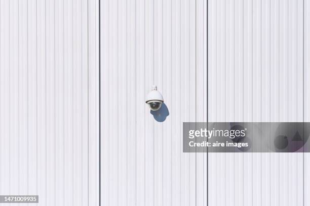 close-up of a security camera installed on the exterior of a building, front view - security camera view stock pictures, royalty-free photos & images