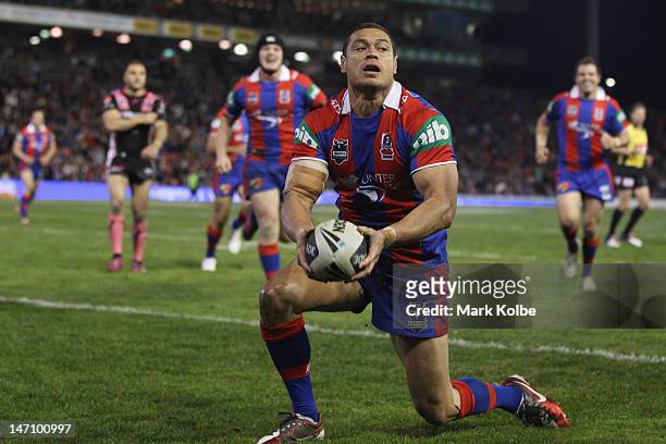 Timana Tahu of the Knights celebrates scoring a try during the round 16 NRL match between the Newcastle Knights and the Wests Tigers at Hunter...