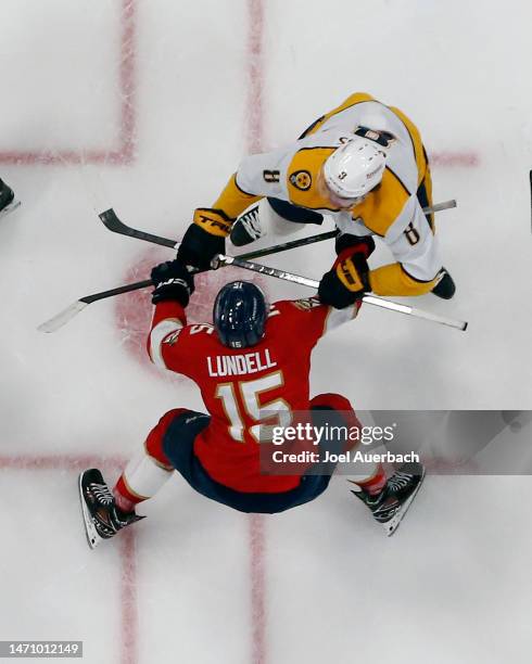 Cody Glass of the Nashville Predators and Anton Lundell of the Florida Panthers battle in the face-off circle at the FLA Live Arena on March 2, 2023...