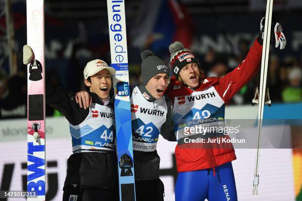 Ryoyu Kobayashi of Japan, Timi Zajc of Slovenia and Dawid Kubacki of Poland celebrate following the Ski Jumping Men's Individual HS138 Competition at...