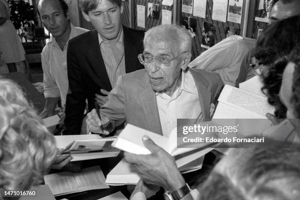 American film director George Cukor as autographs books during the Venice Film Festival, Venice, Italy, September 4, 1982. During the festival, he...