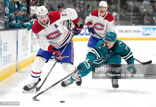 Josh Anderson of the Montreal Canadiens skating with the puck keeping it away from Nico Sturm of the San Jose Sharks during the first period at SAP...