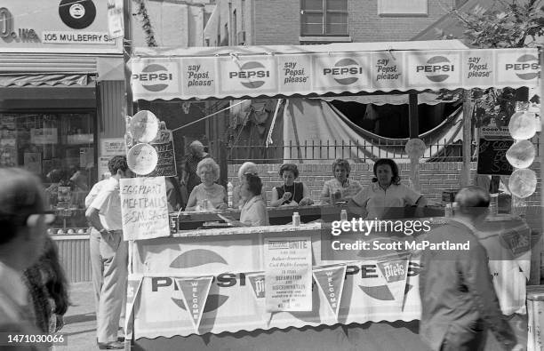 View of vendors and seated customers at a booth on Mulberry Street during the Feast Of San Gennaro Festival, in the Little Italy neighborhood, New...
