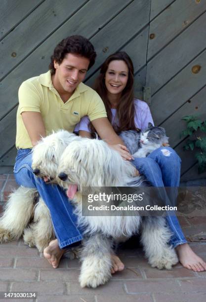 Actor Ed Lottimer and his wife, American actress Mary Crosby, pose for a portrait with their dogs and cat in Los Angeles, California, circa 1980.