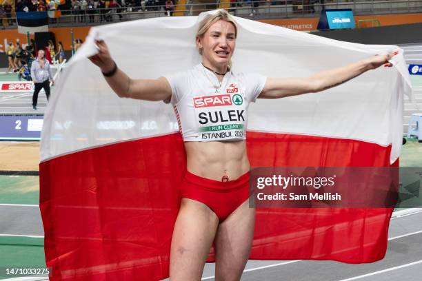 Adrianna Suek, of Poland celebrates with a Polish flag following the womens 800m Pentathlon Final during the European Athletics Indoor Championships...