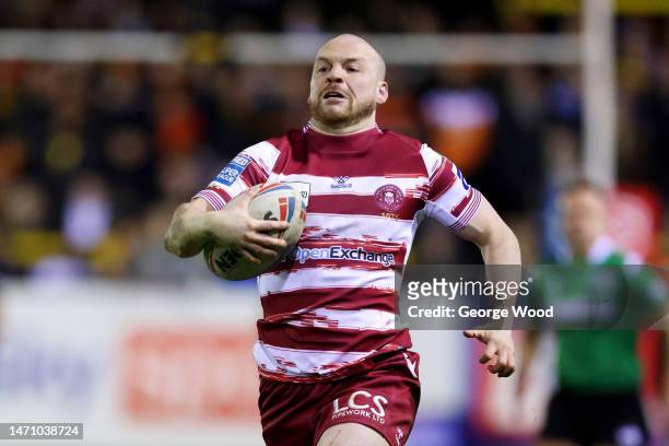 Liam Marshall of Wigan Warriors breaks away to score the team's third try during the Betfred Super League between Castleford Tigers and Wigan...