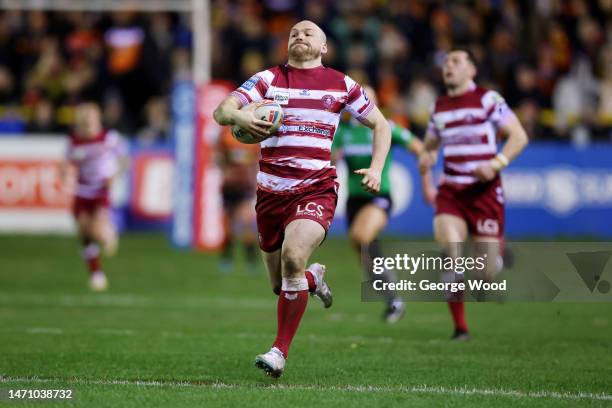 Liam Marshall of Wigan Warriors breaks away to score the team's third try during the Betfred Super League between Castleford Tigers and Wigan...