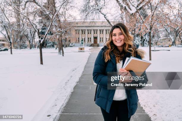 cute portrait of a cheerful university student standing looking at camera on campus on a snowy day in colorado - colorado state university stock pictures, royalty-free photos & images