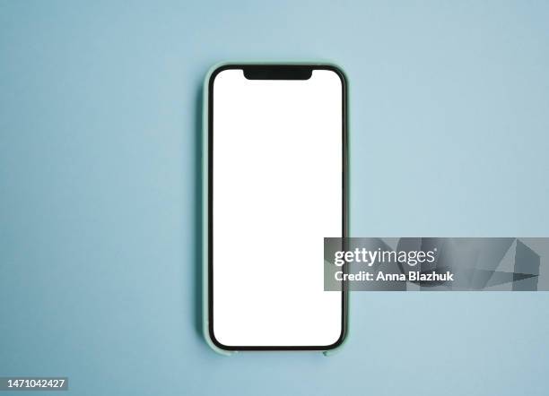 smartphone with white blank screen for mockup or copy space over blue background - mockup smartphone stockfoto's en -beelden