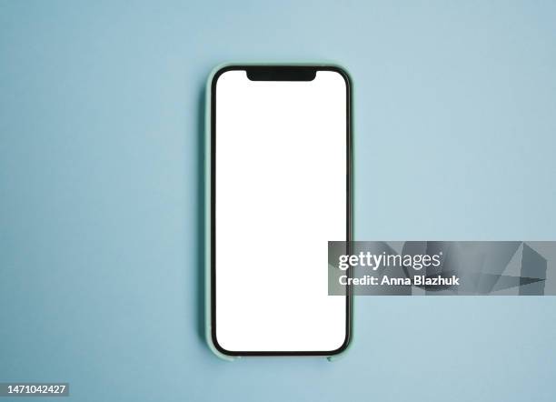 smartphone with white blank screen for mockup or copy space over blue background - portability stock pictures, royalty-free photos & images