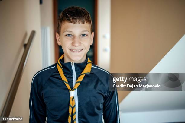 boy standing at home proud to be a scout - one teenage boy only stock pictures, royalty-free photos & images