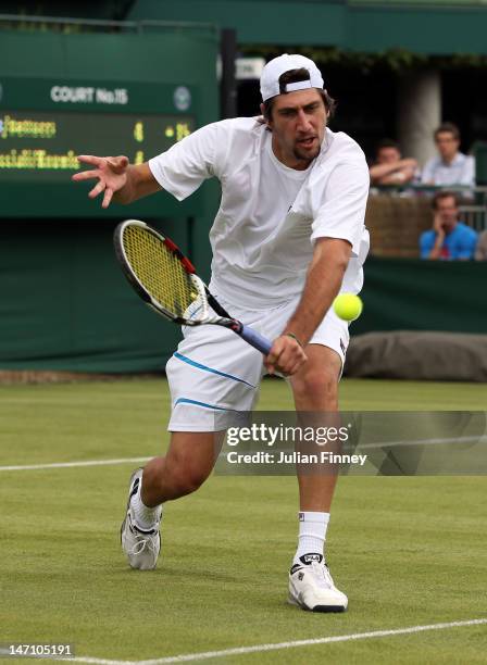 Carsten Ball of Australia eyes the ball during his gentlemen's doubles first round match alongside team-mate Thomasz Bellucci of Brazil against...