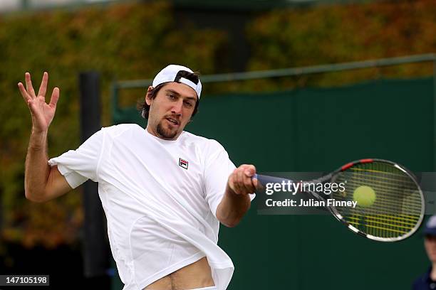 Carsten Ball of Australia hits a forehand return during his gentlemen's doubles first round match alongside team-mate Thomasz Bellucci of Brazil...