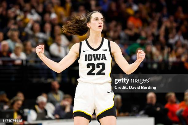 Caitlin Clark of the Iowa Hawkeyes celebrates her three-point basket against the Purdue Boilermakers in the second half of the game in the...