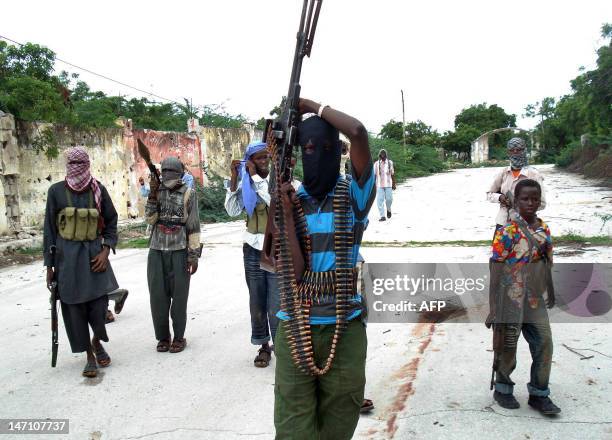 Somali Islamist insurgents patrol a street in the Tarbunka area of Mogadishu on June 17, 2009 during the second day of clashes between government...
